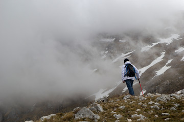 Obraz premium hiker on mountain peak in matese park and fog