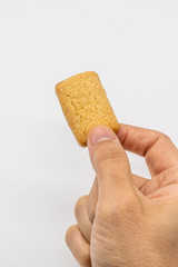Hand holding the homemade cookie isolated on white