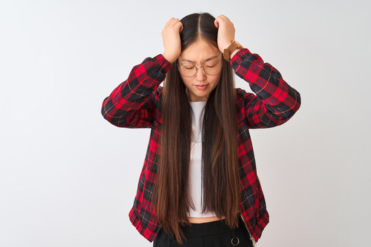 Young chinese woman wearing casual jacket and glasses over isolated white background suffering from headache desperate and stressed because pain and migraine. Hands on head.