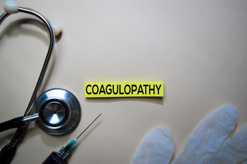 Coagulopathy text on Sticky Notes. Top view isolated on office desk. Healthcare/Medical concept