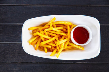 French fries with ketchup on wood table