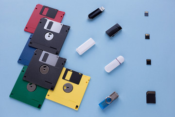 The evolution of digital data storage device. Floppy disks, flash drives and small memory cards.