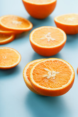 Slices and slices of orange pulp on a bright blue background as a textural background, the substrate. Full screen Flat lay, top view. Food background