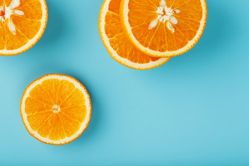 Slices and slices of orange pulp on a bright blue background as a textural background, the substrate. Full screen Flat lay, top view. Food background