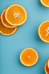 Slices and slices of orange pulp on a bright blue background as a textural background, the substrate. Full screen Flat lay, top view. Food background