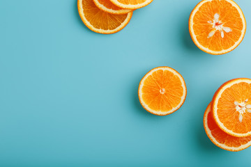 Slices and slices of orange pulp on a bright blue background as a textural background, the substrate. Full screen Flat lay, top view. Food background