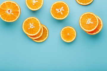 Slices and slices of orange pulp on a bright blue background as a textural background, the substrate. Full screen Flat lay, top view. Food background