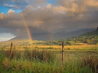 Two rainbows in a green field, Dramatic clouds, Connemara national park, Ireland.