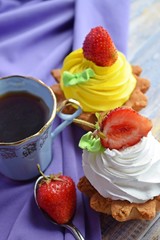 Fragrant tea and delicious cakes baskets of short pastry with jam and cream.
