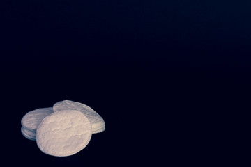 cotton pads on black background