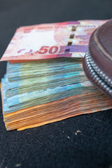 A close up view of pile of two hundred, one hundred and fifty rand sound african notes spread out...