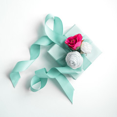 Green gift box with a green ribbon on a white background .