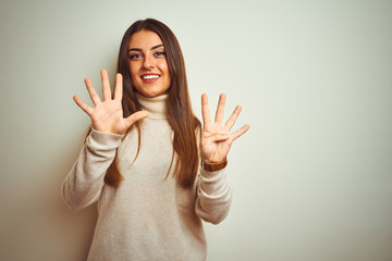 Young beautiful woman wearing winter turtleneck sweater over isolated white background showing and...