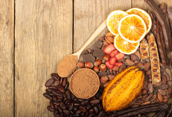 Fototapeta na wymiar cacao pods, carob pods and dried fruits on wooden background