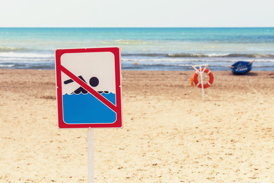 Sign on the beach prohibiting swimming in the sea