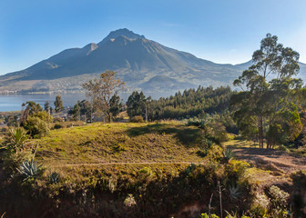 Beautiful view of the Imbabura volcano, the San Pablo lake and green fields, on a beautiful day. Ecuador, South America