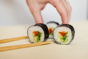sushi with chopsticks isolated on white background