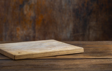 Kitchen table with empty cutting board for montage your object