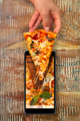 Seafood pizza Order and food delivery from your smartphone. Smartphone on wooden background
