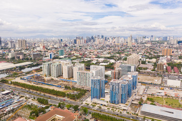 Fototapeta na wymiar Construction of high modern houses in Manila. The city of Manila, the capital of the Philippines. Modern metropolis in the morning, top view. New buildings in the city.