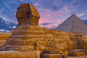 Fototapeta na wymiar Sphinx against the backdrop of the great Egyptian pyramids. Africa, Giza Plateau. 