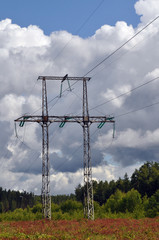 Electricity pylon with blue sky in the field