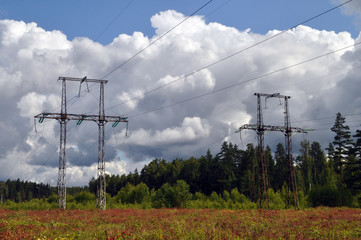 Electricity pylon with blue sky in the field