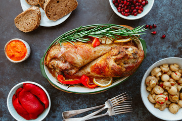 Festive dish for Thanksgiving, roasted turkey legs with vegetables on a table with snacks. Top view, flat lay.