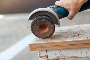 Hand holding grinding machine close up