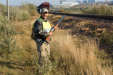 Hunter with a german drathaar and spaniel, pigeon hunting with dogs in reflective vests	