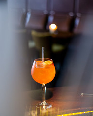 an orange cocktail on a bar
