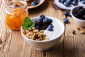 Morning meal, homemade granola with yogurt, fresh summer berries, fruits