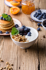 Morning meal, homemade granola with yogurt, fresh summer berries, fruits