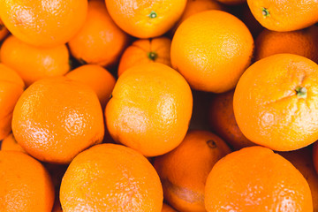 Closeup of many juicy ripe oranges on the counter - traditional Mediterranean market - selected top-quality natural products