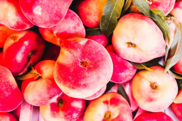 Closeup of many juicy ripe peaches on the counter - traditional Mediterranean market - selected top-quality natural products