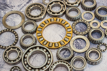 Different bearings on a concrete background.