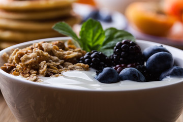Morning meal, homemade granola with yogurt, fresh summer berries, fruits