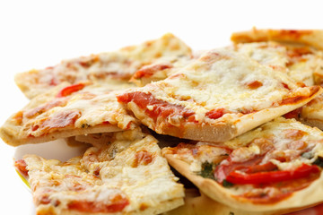 Homemade sliced pizza on white background, close-up shot
