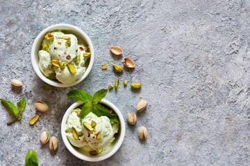 Pistachio ice cream with mint on a stone background. Green ice cream. View from above.