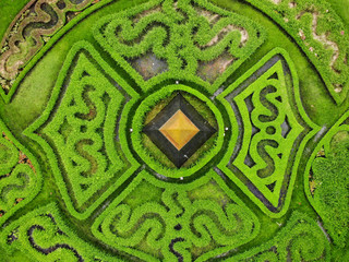 Aerial view Benchasiri Park next Sukhumvit street, Bangkok, Thailand. Green bush circular composition with pointed statue in the middle