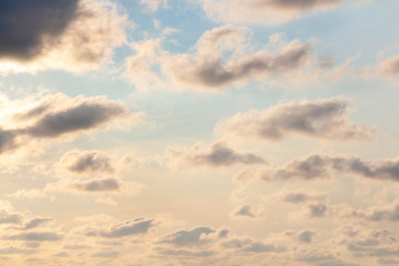 Sky blue and orange light of the sun through the clouds in the sky.