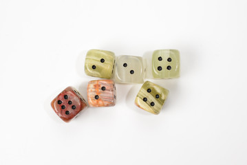 Dices made of natural stone on a white background. Copy space. Gaming.