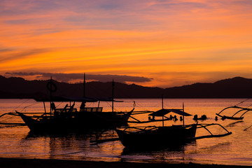 Sunset with typical boats in Port Barton, Philippines, Palawan Island