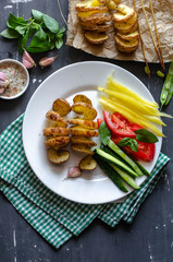 Homemade Tornado spiral baked potato with vegetable salad. Tomatoes cucumber pepper