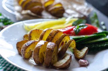 Homemade Tornado spiral baked potato with vegetable salad. Tomatoes cucumber pepper