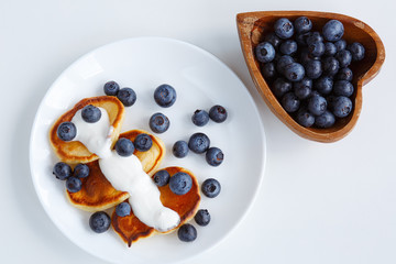 plate with pancakes with blueberries and yogurt