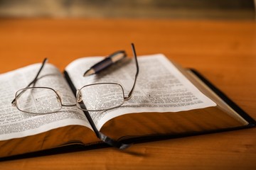 Open Bible with Pen and Eyeglasses