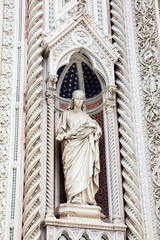 Statue on the facade of the beautiful Florence Cathedral formally called Cattedrale di Santa Maria...