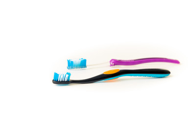 His and her toothbrush on a white background.