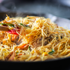 Process of cooking of sweet and crunchy stir fry with beansprouts and noodles in the wok, Macro image